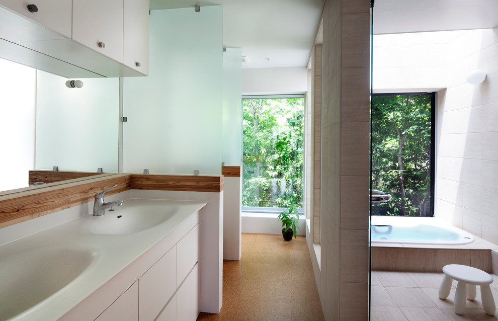 横浜にあるモダンスタイルのおしゃれな浴室 (フラットパネル扉のキャビネット、白いキャビネット、ドロップイン型浴槽、ベージュの壁、一体型シンク) の写真