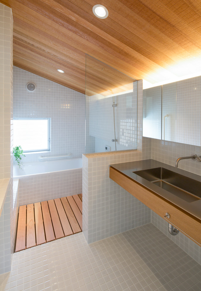 Design ideas for a small world-inspired ensuite bathroom in Nagoya with open cabinets, grey cabinets, a submerged bath, a built-in shower, white tiles, mosaic tiles, white walls, mosaic tile flooring, a submerged sink, stainless steel worktops, white floors, a shower curtain, grey worktops, a single sink, a freestanding vanity unit and a wood ceiling.