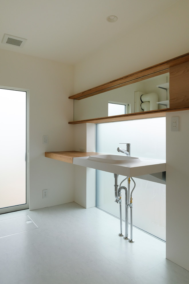 Diseño de cuarto de baño minimalista con paredes blancas, lavabo encastrado y suelo blanco