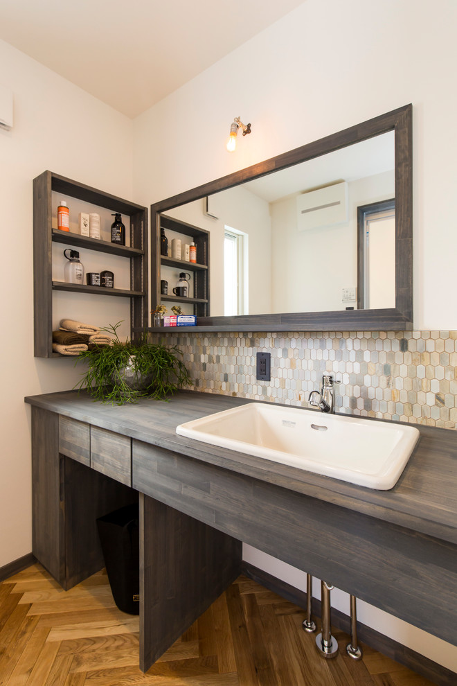 Идея дизайна: ванная комната в современном стиле с плоскими фасадами, белыми стенами, паркетным полом среднего тона, накладной раковиной, коричневым полом и темными деревянными фасадами