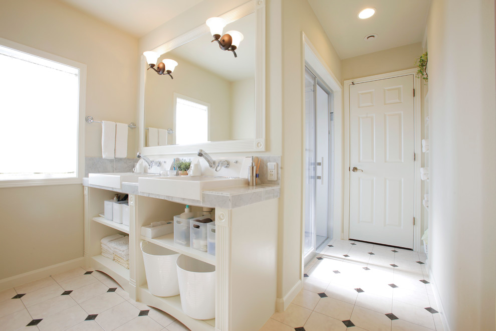 Traditional bathroom in Other with open cabinets, white cabinets and white walls.