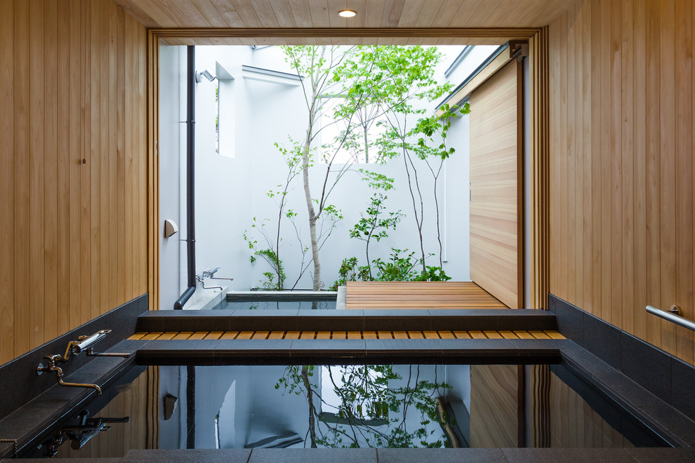 Réalisation d'une salle de bain minimaliste avec une baignoire d'angle, un mur marron et une fenêtre.