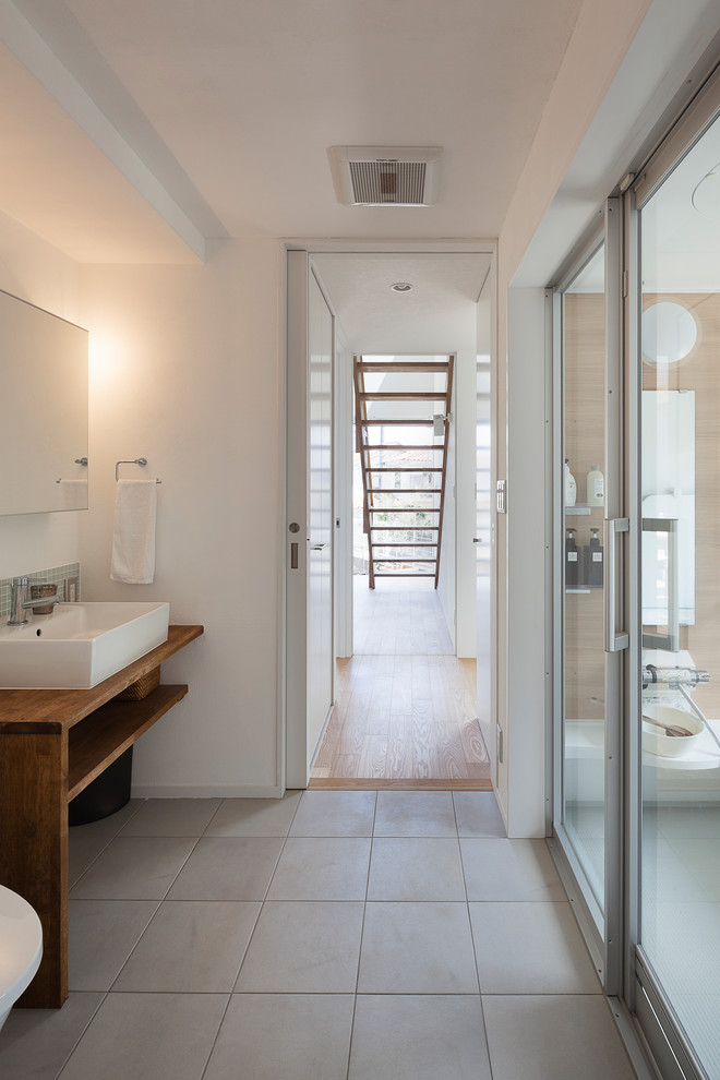 Photo of a contemporary bathroom in Other with white walls and grey floors.