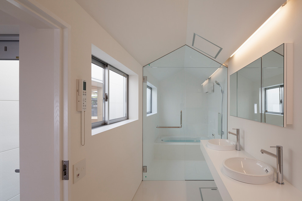 Inspiration pour une salle de bain design avec une baignoire d'angle, une douche ouverte, un mur blanc, un lavabo posé, un sol blanc et aucune cabine.
