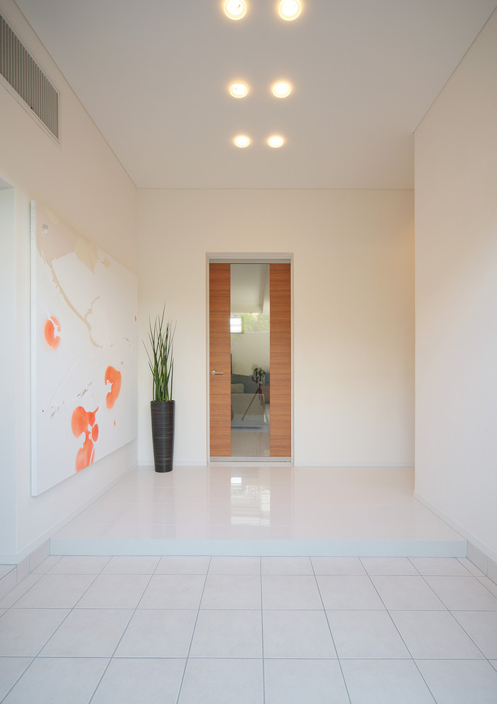 Inspiration for a modern foyer in Tokyo with white walls and white floors.
