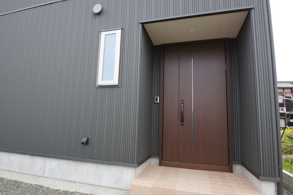 Moderner Eingang mit schwarzer Wandfarbe, Porzellan-Bodenfliesen, Doppeltür, dunkler Holzhaustür und beigem Boden in Sonstige