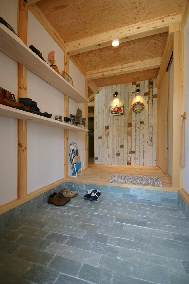 Imagen de hall actual con paredes blancas, suelo de madera clara, puerta simple y puerta de madera en tonos medios