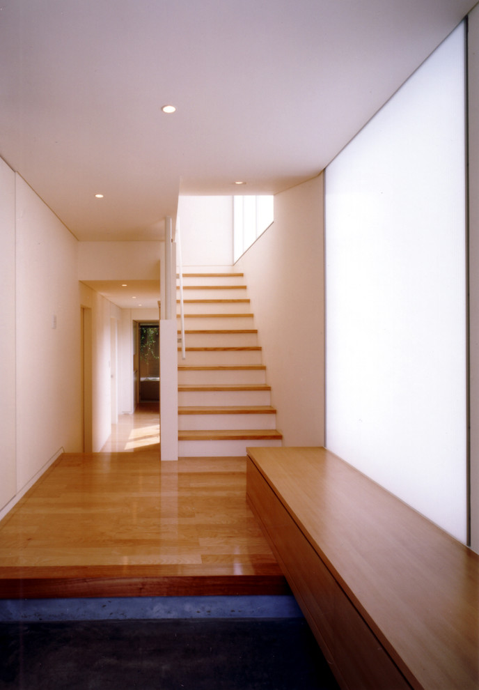 Idee per un ingresso o corridoio minimalista con pareti bianche, pavimento in cemento, una porta singola, una porta in metallo e pavimento grigio