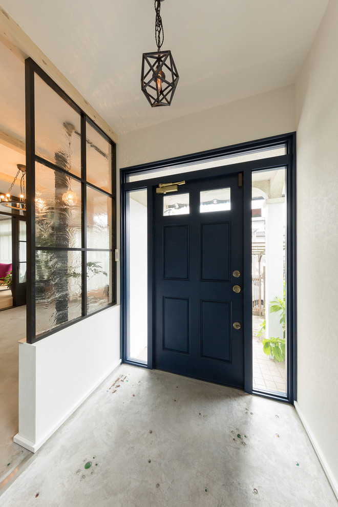Eclectic entrance in Other with white walls, concrete flooring, a single front door, a black front door and grey floors.