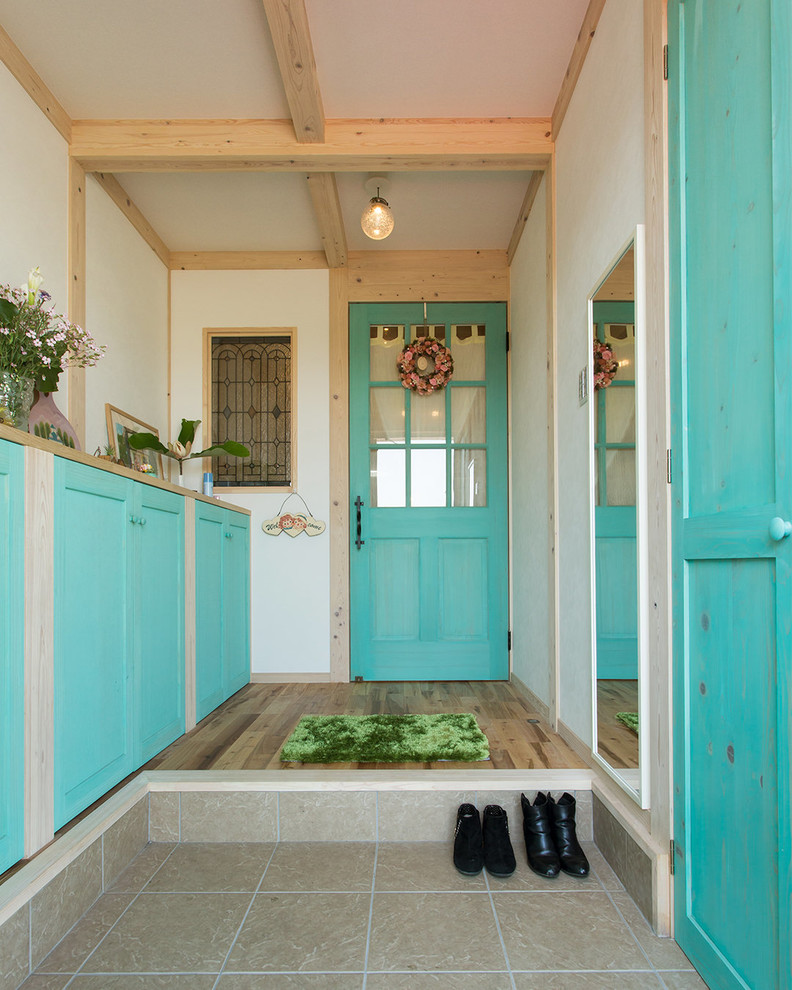 Photo of a mediterranean hallway in Other with white walls and beige floors.