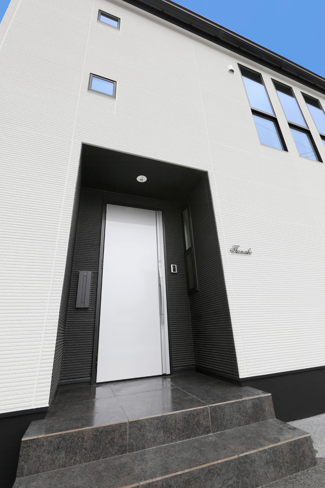 Contemporary entrance in Other with a white front door.