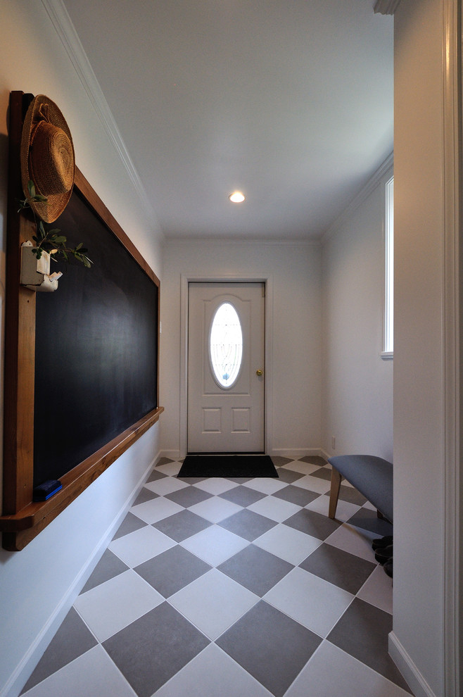 Ispirazione per un corridoio vittoriano con pareti bianche, una porta singola, una porta bianca e pavimento multicolore