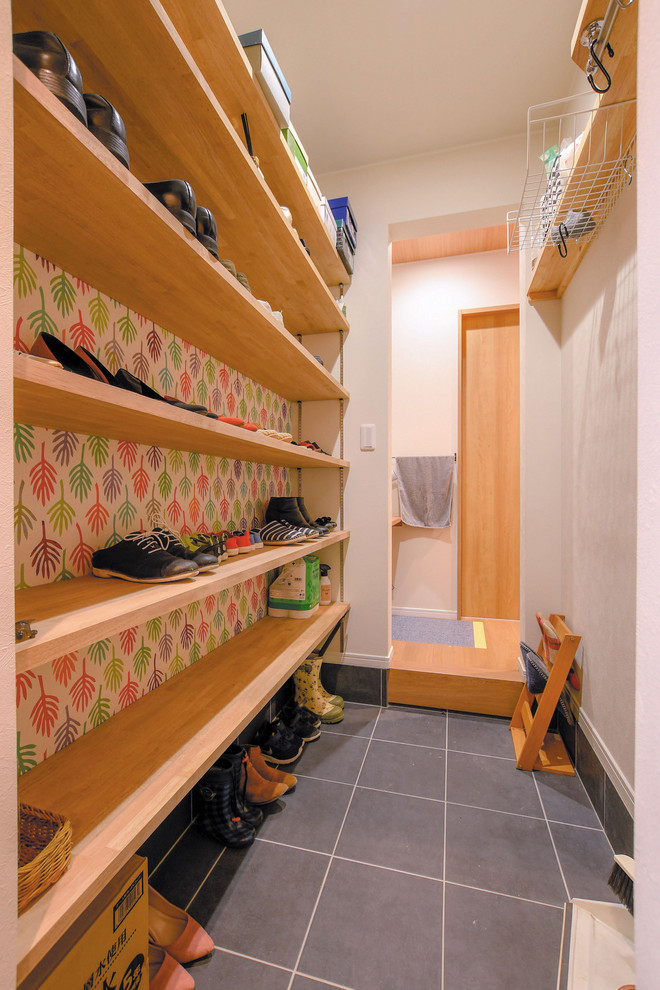 Photo of a small scandinavian boot room in Other with multi-coloured walls, porcelain flooring and grey floors.
