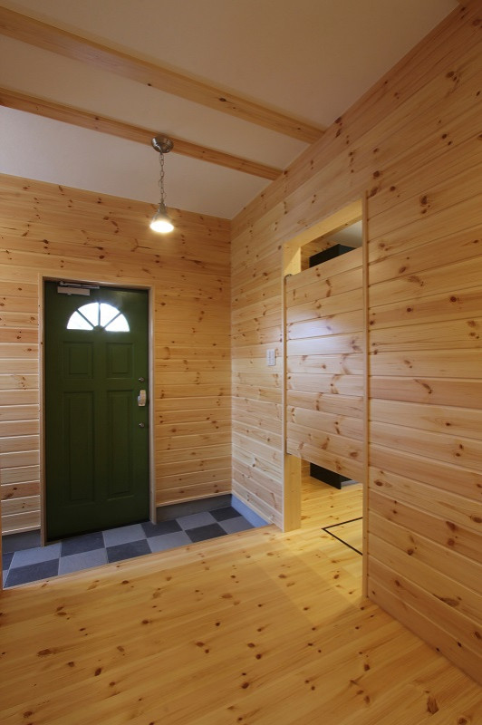 На фото: узкая прихожая среднего размера в стиле лофт с бежевыми стенами, светлым паркетным полом, одностворчатой входной дверью, зеленой входной дверью, бежевым полом, балками на потолке и панелями на стенах