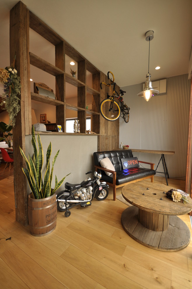 Example of an urban medium tone wood floor and brown floor entryway design in Osaka with gray walls