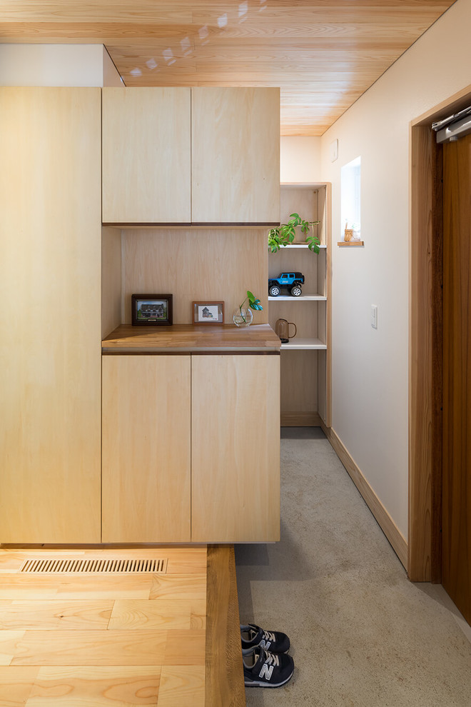Inspiration for a zen light wood floor and beige floor entryway remodel in Tokyo Suburbs with white walls and a dark wood front door