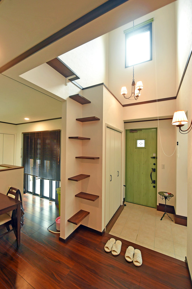 Design ideas for a hallway in Tokyo Suburbs with a green front door and brown floors.