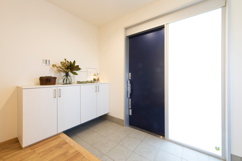 Пример оригинального дизайна: узкая прихожая в стиле модернизм с белыми стенами, одностворчатой входной дверью, синей входной дверью и потолком с обоями