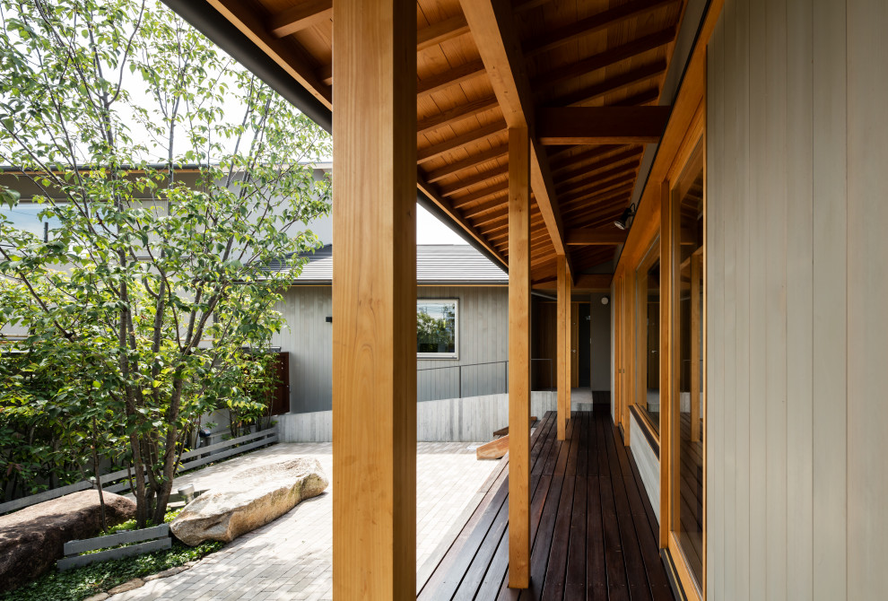 This is an example of a world-inspired front veranda in Other with decking.