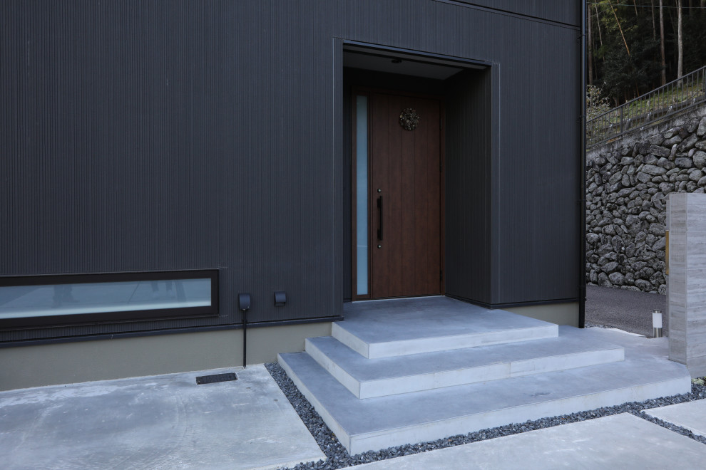Idee per un portico minimalista di medie dimensioni e davanti casa con pavimentazioni in cemento