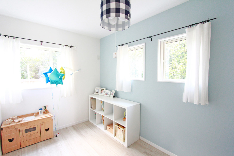 Medium sized scandinavian nursery for boys in Tokyo Suburbs with white walls, light hardwood flooring and beige floors.