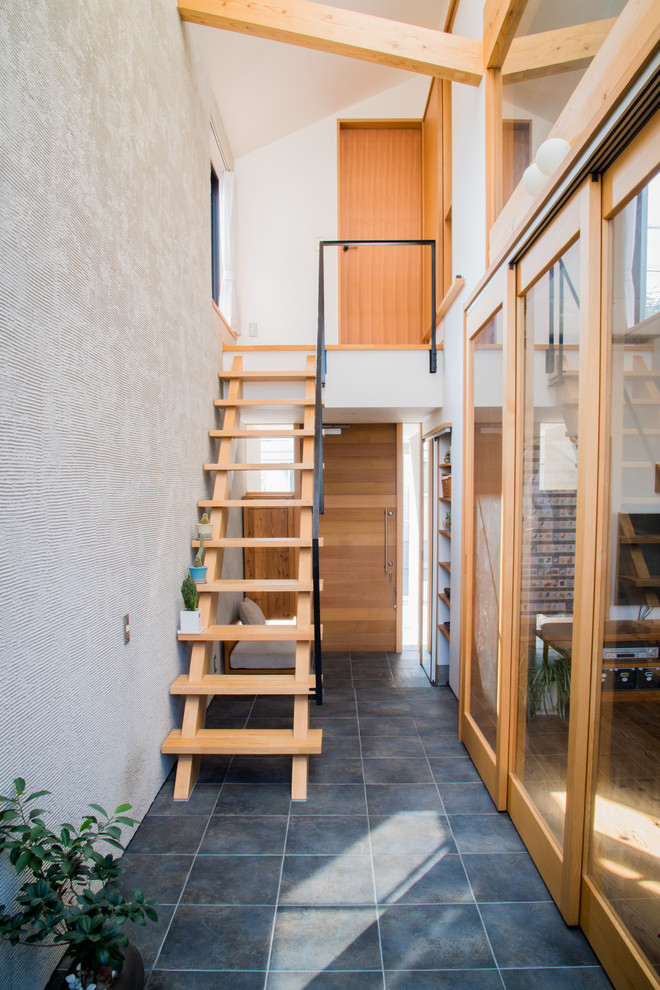 Inspiration pour un escalier sans contremarche droit minimaliste de taille moyenne avec des marches en bois et un garde-corps en métal.