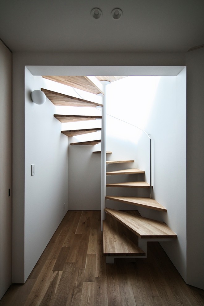 World-inspired wood spiral staircase in Nagoya with open risers.