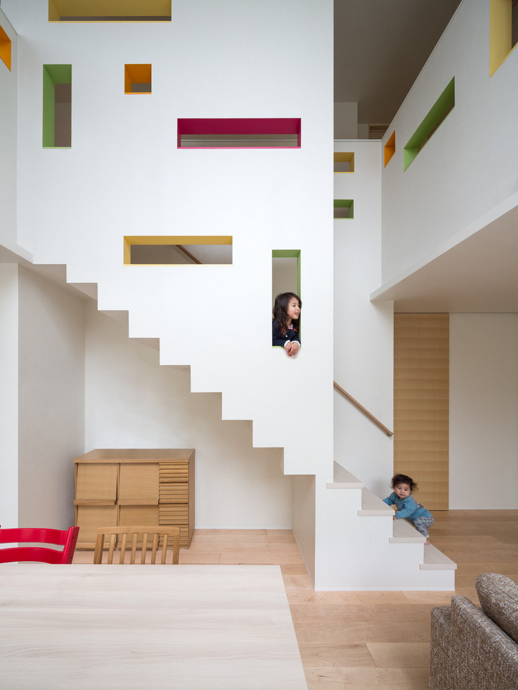 На фото: прямая лестница в стиле модернизм с деревянными ступенями, крашенными деревянными подступенками и деревянными перилами с