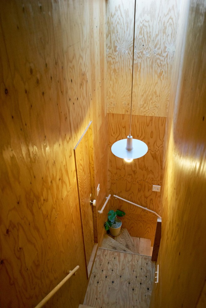 Small wood wood railing staircase in Tokyo with wood risers.