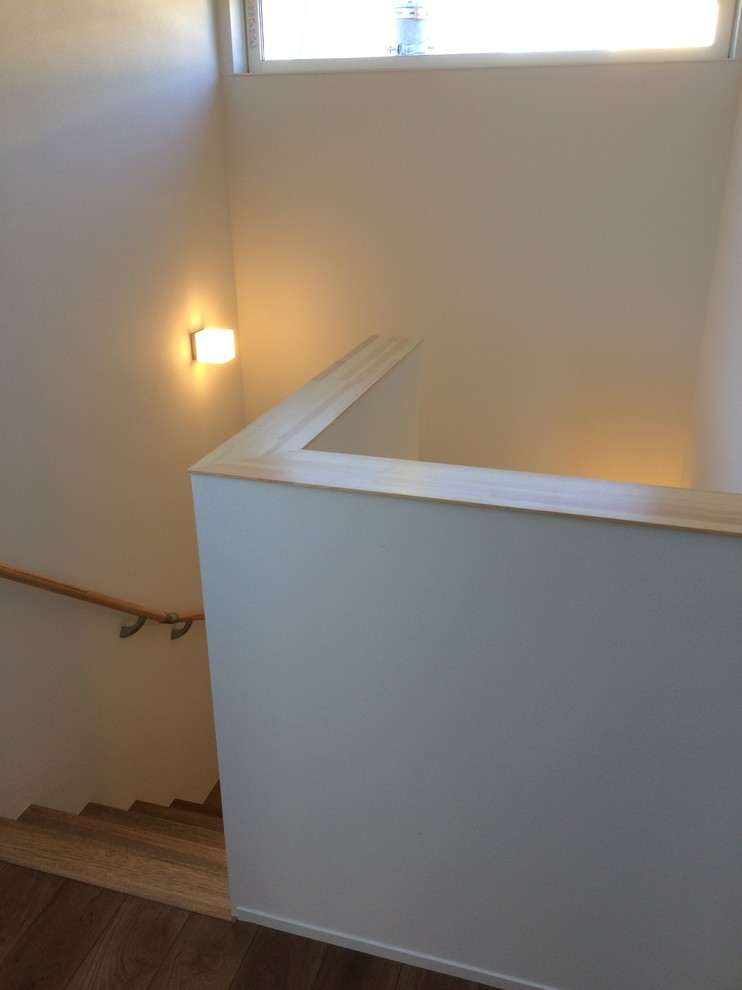 Foto de escalera en U moderna de tamaño medio sin contrahuella con escalones de madera