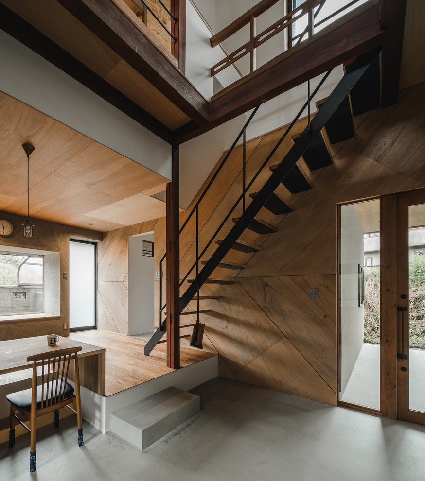 Design ideas for an expansive world-inspired wood straight metal railing staircase in Other with open risers.