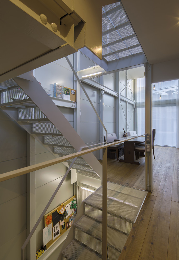 Staircase - small modern metal u-shaped metal railing staircase idea in Osaka with metal risers