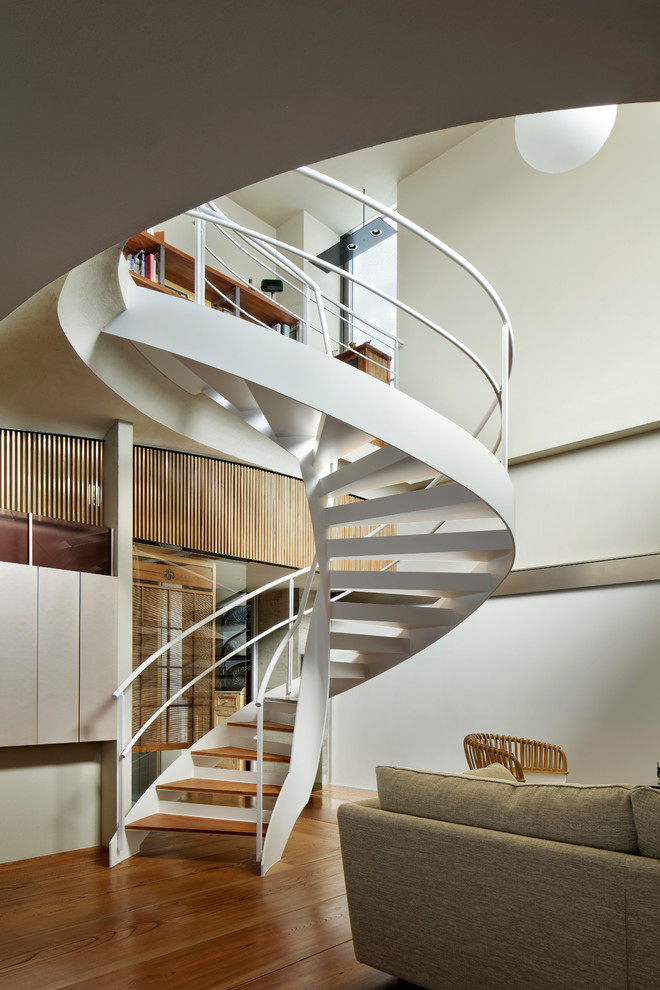 Contemporary wood spiral metal railing staircase in Tokyo with open risers.