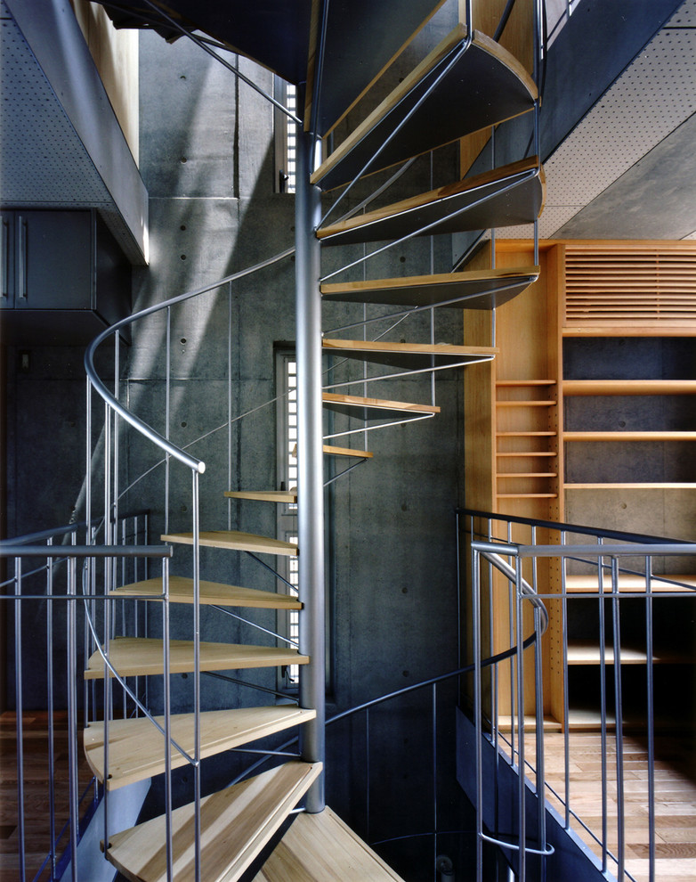 This is an example of an industrial wood spiral staircase in Tokyo with open risers.