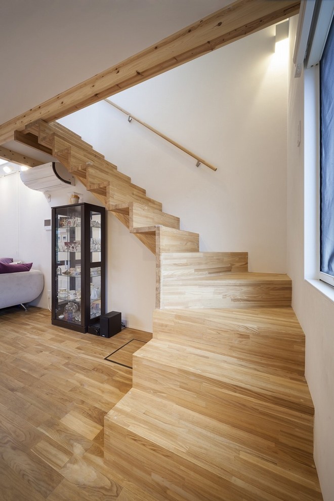 Example of a cottage wooden curved wood railing staircase design in Other with wooden risers
