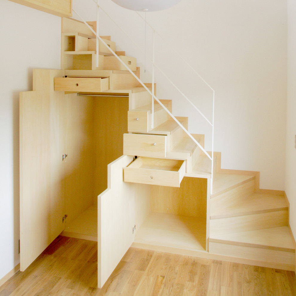 Contemporary wood curved staircase in Yokohama with wood risers.