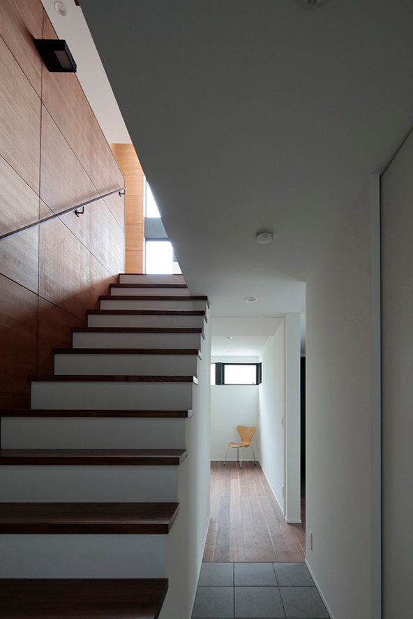 Foto de escalera recta moderna con escalones de madera y barandilla de metal