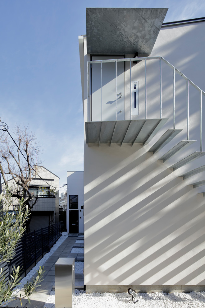 Minimalist metal straight open and metal railing staircase photo in Tokyo