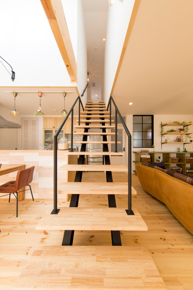 World-inspired wood straight staircase in Other with open risers.
