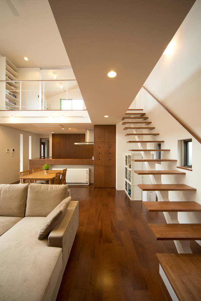 Photo of a world-inspired wood straight staircase in Other with open risers.