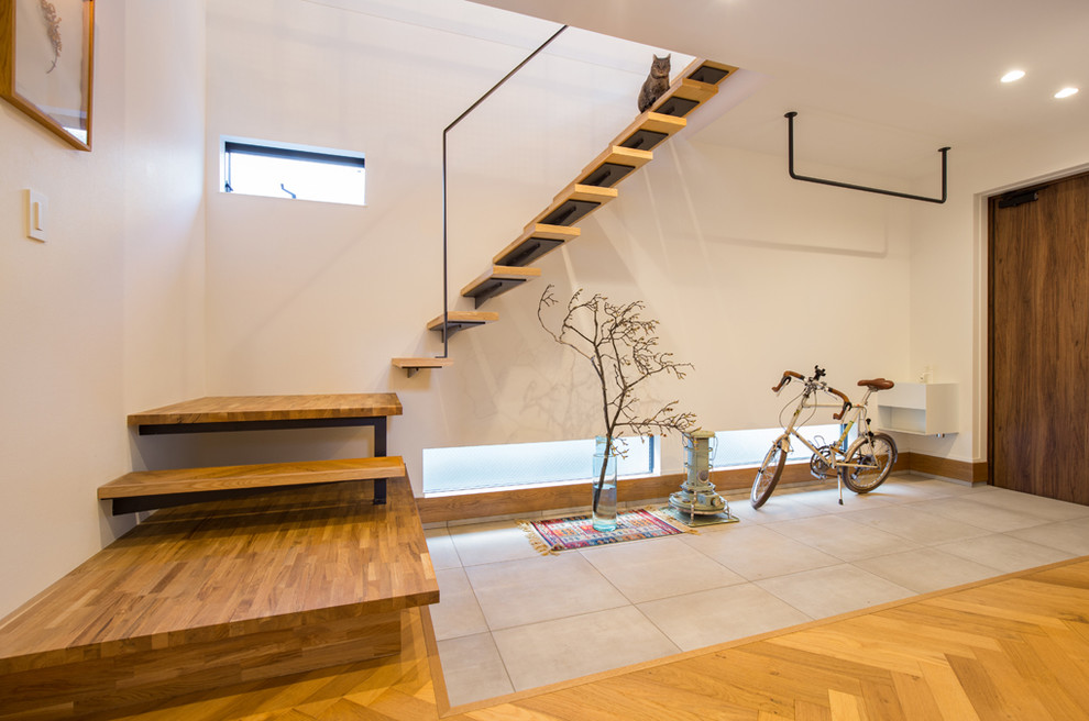 Inspiration for a mid-sized asian wooden straight open and metal railing staircase remodel in Nagoya