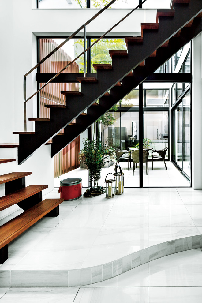 Photo of a contemporary wood straight metal railing staircase in Tokyo Suburbs with open risers.