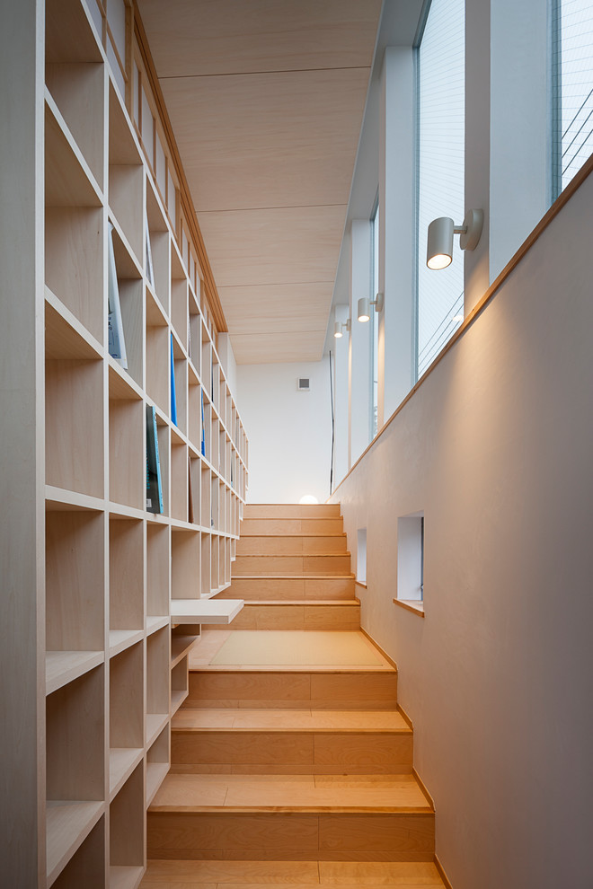 Modern wood straight staircase in Tokyo with wood risers.