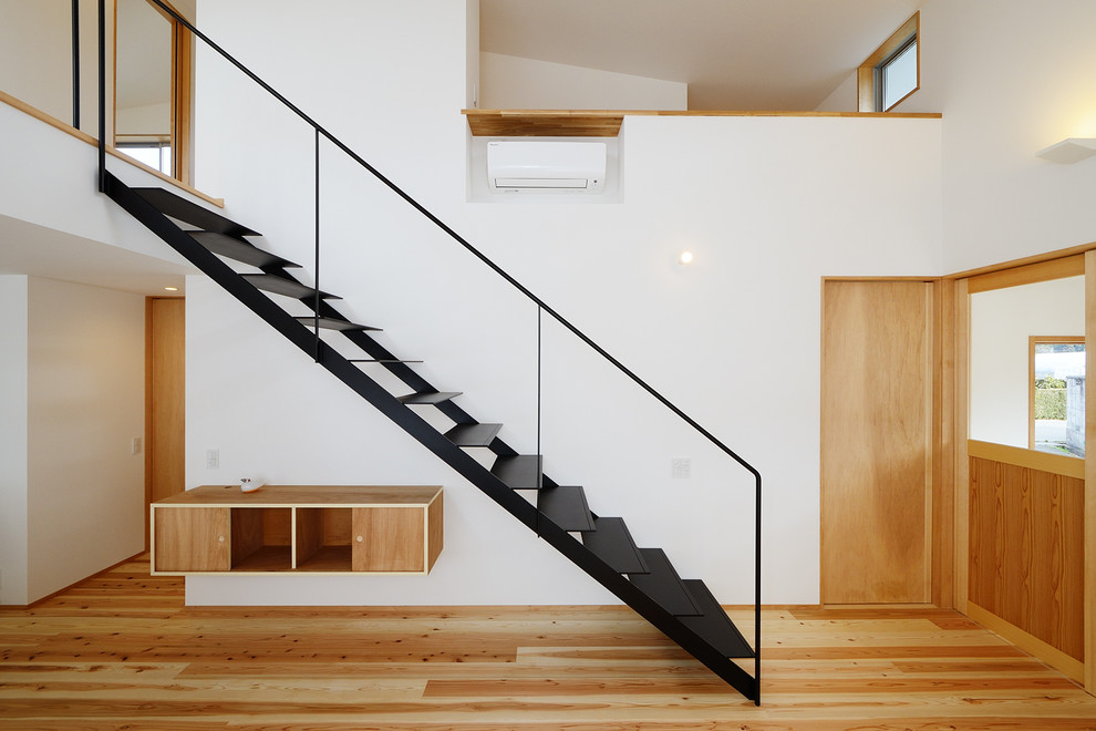Inspiration for a large scandinavian wood floating metal railing staircase in Other with wallpapered walls.